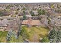 An aerial view shows a house nestled among mature trees, in a private and quiet neighborhood at 2205 Lake Park Dr, Longmont, CO 80503