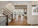 Inviting living room featuring hardwood floors, a stone fireplace, and an open floor plan at 2966 Casalon Cir, Superior, CO 80027