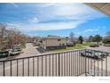 Scenic balcony view overlooking a quiet neighborhood street with well-maintained landscaping and community charm at 3354 S Flower St # 68, Lakewood, CO 80227