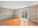 Bright living room featuring hardwood floors and sliding glass doors to the balcony, perfect for relaxation at 3354 S Flower St # 68, Lakewood, CO 80227