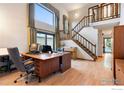 Bright home office featuring a staircase, piano, high ceilings, and large windows at 337 Eagle Ct, Longmont, CO 80504