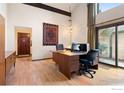 Spacious office featuring laminate floors, high ceilings, and a sliding door to the outside at 337 Eagle Ct, Longmont, CO 80504