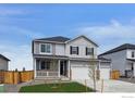 Charming two-story home with a three-car garage and inviting front yard at 4211 Sandstone Dr, Mead, CO 80504