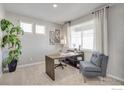 Bright home office with large window, comfortable chair, and stylish desk at 4211 Sandstone Dr, Mead, CO 80504