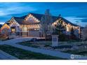 Well maintained home showcasing the spacious driveway, landscaping, and charming details at 441 Dusk Pl, Erie, CO 80516
