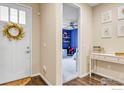 Inviting foyer featuring a lovely wreath and an open view to the study at 441 Dusk Pl, Erie, CO 80516