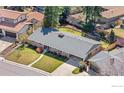 Aerial view of a single-story home with a well-manicured lawn and long driveway at 545 S Harrison Ln, Denver, CO 80209