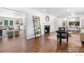 Spacious living room features hardwood floors, a fireplace, and an open floor plan at 545 S Harrison Ln, Denver, CO 80209