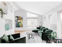 Modern living room with vaulted ceilings, lots of natural light and stylish green furniture at 590 Yuma Cir, Boulder, CO 80303