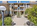 Apartment complex featuring multiple units with balconies and a central staircase and landscaping at 5904 Gunbarrel Ave # B, Boulder, CO 80301