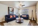 Cozy living room features stylish sofas, a patterned rug, and a ceiling fan for a comfortable atmosphere at 61 Avocet Ct, Longmont, CO 80501