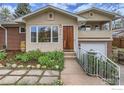 Inviting two-story home with a striking front door and meticulously landscaped pathway at 775 Grape Ave, Boulder, CO 80304