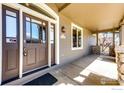 Inviting covered front porch with stone pillars, providing a cozy outdoor space at 789 Zamia Ave, Boulder, CO 80304