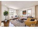Bright living room with large windows, hardwood floors, and stylish furniture at 789 Zamia Ave, Boulder, CO 80304