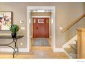 Welcoming foyer features hardwood floors and staircase at 832 Neon Forest Cir, Longmont, CO 80504