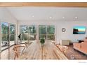 Bright dining room with hardwood floors and large windows overlooking the outside scenery at 8654 Thunderhead Dr, Boulder, CO 80302
