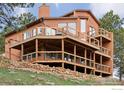 Stunning three-story home featuring multiple decks and rock landscaping at 8654 Thunderhead Dr, Boulder, CO 80302
