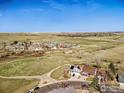 Wide aerial view of homes nestled in a community surrounded by open fields at 9215 W 106Th Ave, Broomfield, CO 80021
