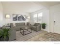Bright living room with neutral decor, wood floors, and stylish furnishings at 9283 Sedalia St, Commerce City, CO 80022
