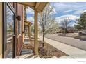 Exterior view featuring townhome entrances, landscaped yards, and a quiet residential street at 1240 Wren Ct # I, Longmont, CO 80501