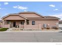 Charming single-story home featuring a welcoming front porch and neutral stucco exterior at 15501 E 112Th Ave # 22A, Commerce City, CO 80022