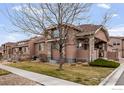A home featuring xeriscaping, stone accents, stucco siding and mature landscaping at 15501 E 112Th Ave # 22A, Commerce City, CO 80022