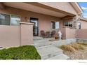 Cozy front porch featuring a small table set, statue and xeriscaping at 15501 E 112Th Ave # 22A, Commerce City, CO 80022