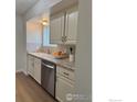 Bright kitchen featuring white cabinets, granite countertops, and stainless steel appliances at 1616 Longbow Ct, Lafayette, CO 80026