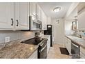 Functional kitchen with white cabinetry, modern appliances, and stylish countertops at 1616 Longbow Ct, Lafayette, CO 80026