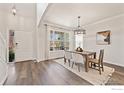 Bright dining room features hardwood floors, modern lighting, and a large window at 16518 Red Rock Ln, Broomfield, CO 80023