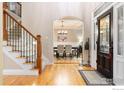 Bright entryway featuring hardwood floors, staircase and dining room view at 1775 Rockies Ct, Lafayette, CO 80026