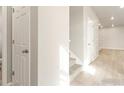 Light and airy entryway with neutral walls, carpeted stairs, and wood-look floors at 255 Mayfly Ln, Berthoud, CO 80513
