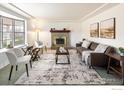 Bright living room with a cozy fireplace, bay window, and stylish furnishings at 2610 Heidelberg Dr, Boulder, CO 80305