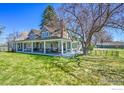Inviting home with a large wrap-around porch perfect for outdoor relaxation and entertaining at 2994 75Th St, Boulder, CO 80301