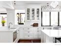 Bright kitchen with white cabinets, stainless steel appliances, tile backsplash, and modern finishes at 3132 5Th St, Boulder, CO 80304