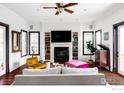 Bright living room featuring a cozy fireplace, built-in shelves, and hardwood floors at 3132 5Th St, Boulder, CO 80304