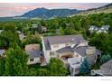 A view of the rear exterior of the house showcasing a patio and lush surroundings with mountain backdrop at 3132 5Th St, Boulder, CO 80304