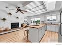 Modern kitchen with white cabinets, butcher block island, brick fireplace and stainless steel appliances at 3205 19Th St, Boulder, CO 80304
