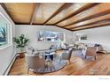 Bright living room with wood-beam ceiling, large windows, and a comfortable seating arrangement at 3205 19Th St, Boulder, CO 80304