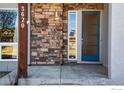 Stylish front entrance with a blue door, stone accents, and visible house numbers at 3620 Paonia St, Boulder, CO 80301