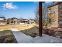 View of a spacious front yard and neighborhood homes from the property's covered porch at 3620 Paonia St, Boulder, CO 80301