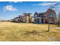 View of a tree-lined street and houses from a property's front yard in a suburban neighborhood at 3620 Paonia St, Boulder, CO 80301