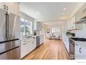 Spacious kitchen featuring stainless steel appliances, white cabinets, and hardwood floors at 3786 Eldorado Springs Dr, Boulder, CO 80303