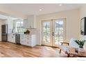 Bright kitchen boasts white cabinets, stainless steel appliances, and views of the backyard at 3786 Eldorado Springs Dr, Boulder, CO 80303