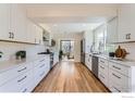 Bright kitchen featuring white cabinets, stainless steel appliances, and hardwood floors at 3786 Eldorado Springs Dr, Boulder, CO 80303