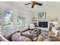 Bright living room with fireplace, large windows showcasing outdoor view, and comfortable seating at 3786 Eldorado Springs Dr, Boulder, CO 80303