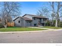 A charming home featuring stylish gray paint, a well-kept lawn, and a convenient attached garage at 4380 Butler Cir, Boulder, CO 80305