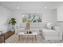 Bright living room with a large comfortable white couch, neutral rug and a large window at 4380 Butler Cir, Boulder, CO 80305