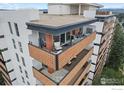Spacious condo balcony with seating offers an inviting outdoor extension with views of the city and mountains beyond at 4570 E Yale Ave # 1104, Denver, CO 80222
