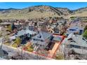 Beautiful aerial view of the property showcasing the home, yard, and surrounding neighborhood with mountain views at 4921 Fountain St, Boulder, CO 80304
